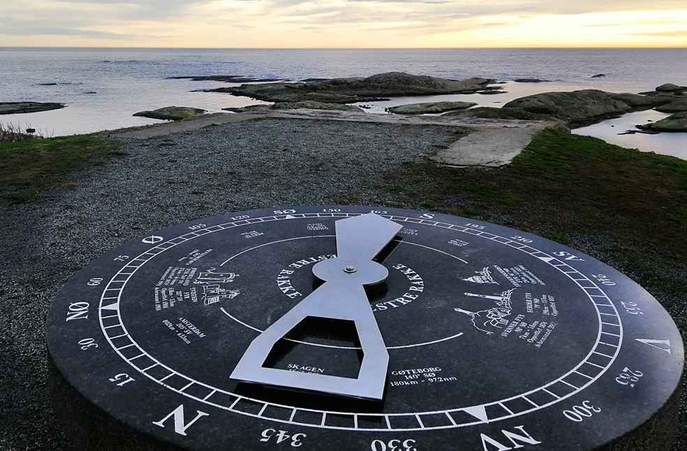 Maritime Crisis 2026: Shipping Losses and Rising Risks 3 Maritime Crisis 2026 illustrated by a coastal direction dial overlooking the sea at sunset